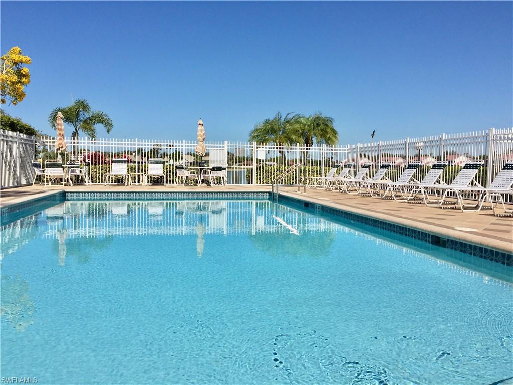 975 Partridge Circle, Unit 202 Naples, FL 34104 - Photo 13 of 16 a view of a lake with a city