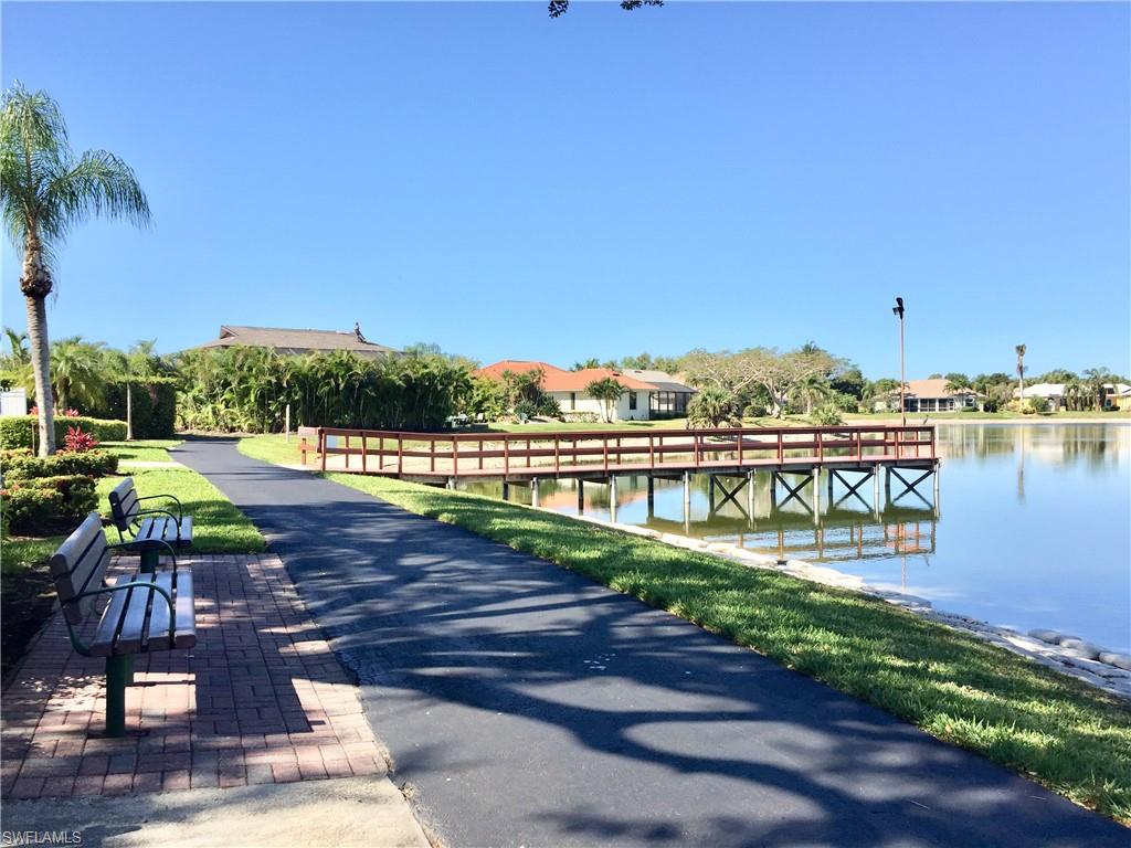 975 Partridge Circle, Unit 202 Naples, FL 34104 - Photo 16 of 16 a view of a lake with a water fall