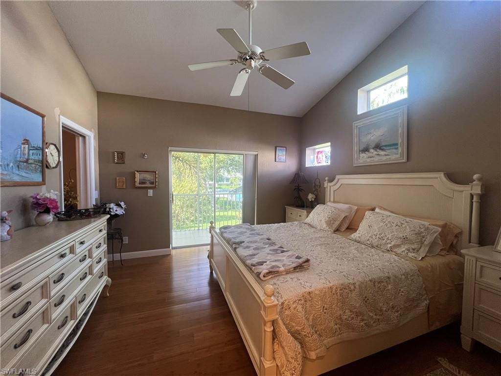 975 Partridge Circle, Unit 202 Naples, FL 34104 - Photo 2 of 16 a bedroom with a bed and a chandelier