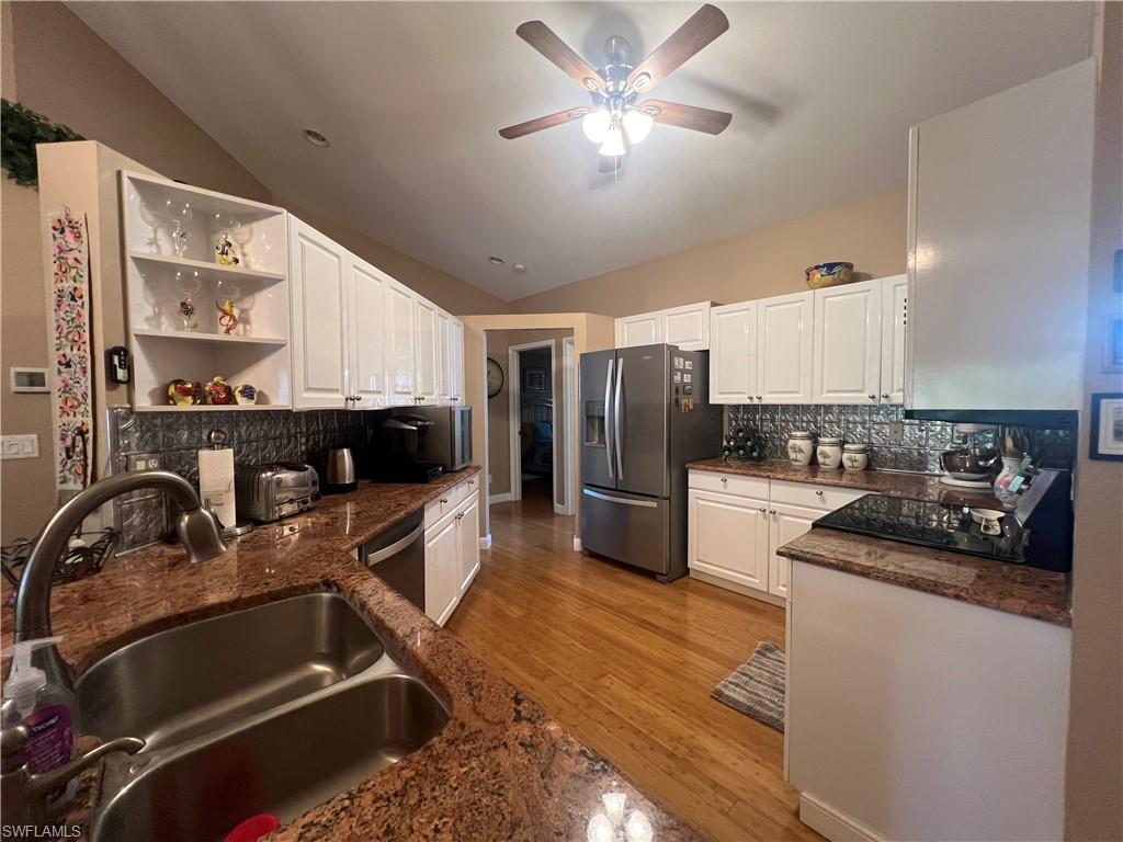 975 Partridge Circle, Unit 202 Naples, FL 34104 - Photo 10 of 16 a kitchen with a refrigerator and a sink