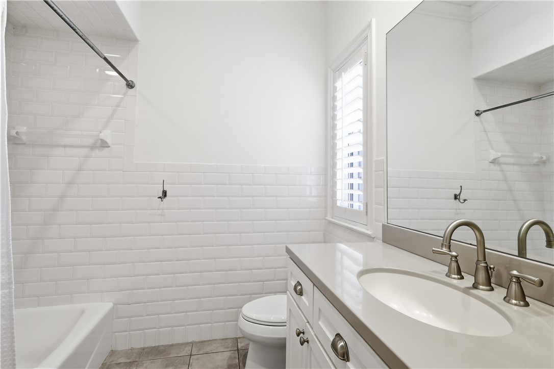 2116 Cavalla Road Vero Beach, FL 32963 - Photo 14 of 23 a bathroom with a granite countertop toilet a sink and a bathtub