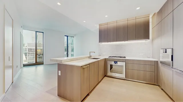 a view of kitchen with stainless steel appliances granite countertop cabinets and wooden floor