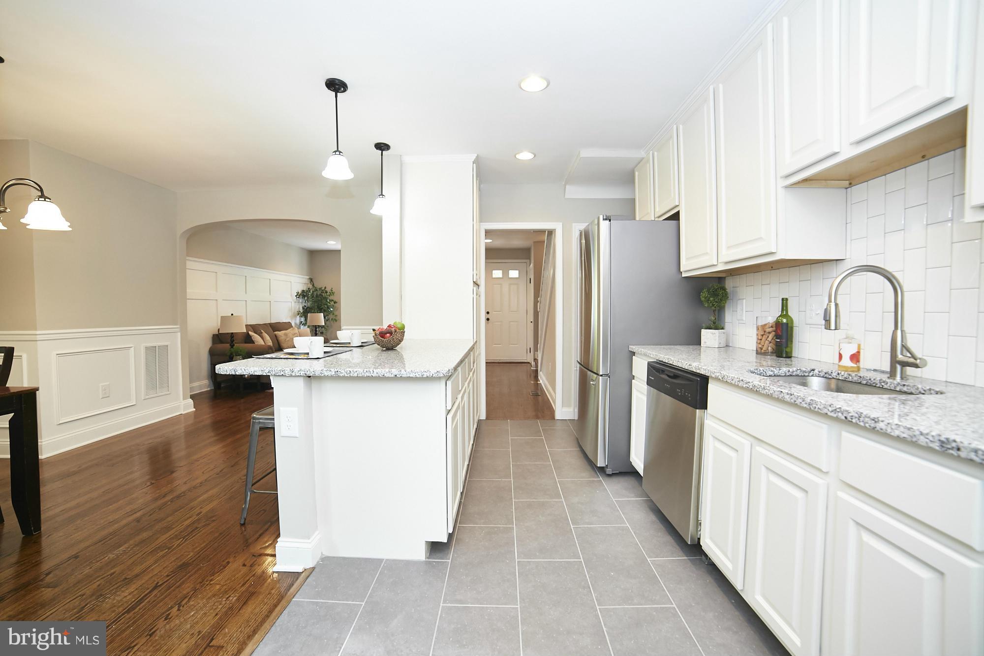 3909 Ednor Road Baltimore, MD 21218 - Photo 14 of 30 a kitchen with a sink refrigerator and cabinets