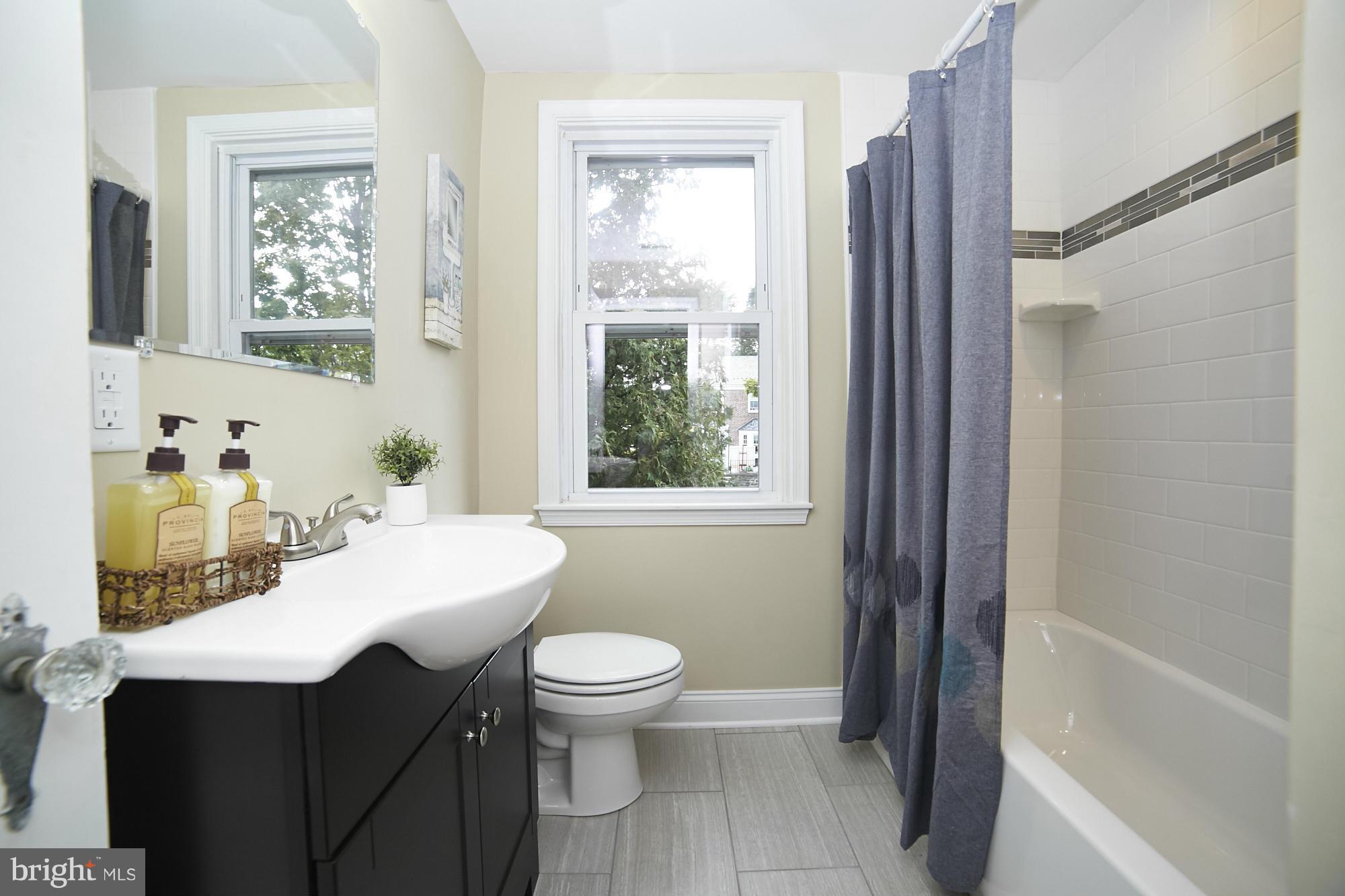 3909 Ednor Road Baltimore, MD 21218 - Photo 22 of 30 a bathroom with a sink toilet and shower