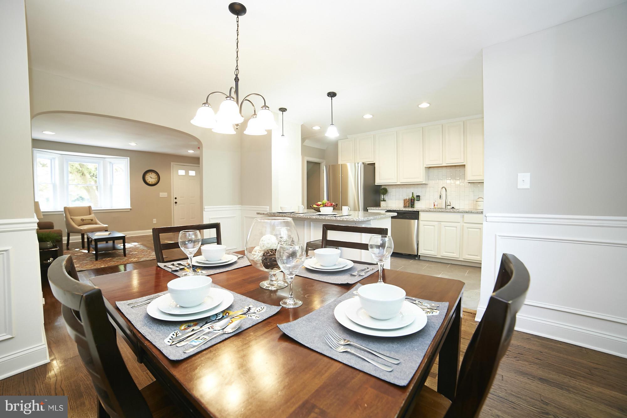 3909 Ednor Road Baltimore, MD 21218 - Photo 8 of 30 a dining room with furniture kitchen view and a chandelier