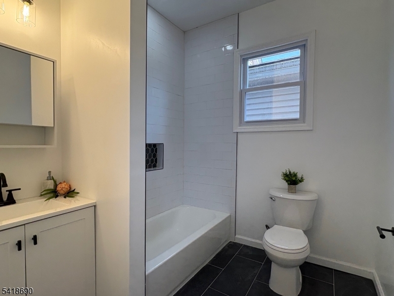 456 Harrison Street, Unit 2 Passaic, NJ 07055 - Photo 12 of 17 a bathroom with a toilet sink and bathtub