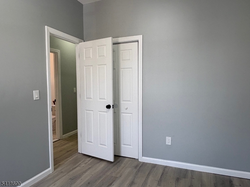 456 Harrison Street, Unit 2 Passaic, NJ 07055 - Photo 13 of 17 a view of an empty room with wooden floor