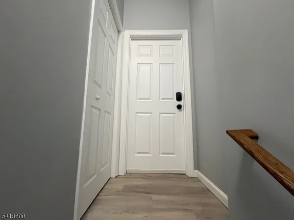 a view of a hallway with wooden floor
