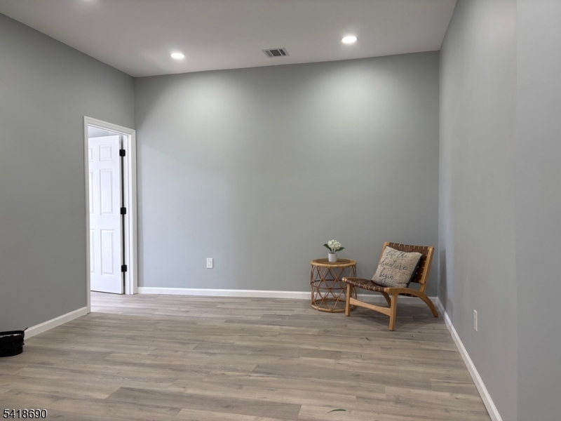 456 Harrison Street, Unit 2 Passaic, NJ 07055 - Photo 5 of 17 a view of room with wooden floor and chairs