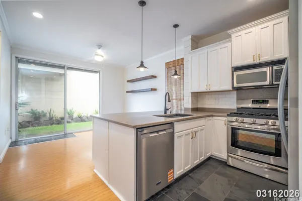 a kitchen with stainless steel appliances granite countertop a stove and a sink