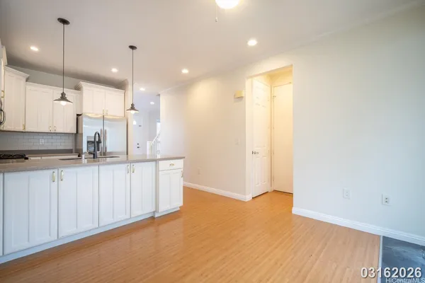 a view of a kitchen with a sink and wooden floor