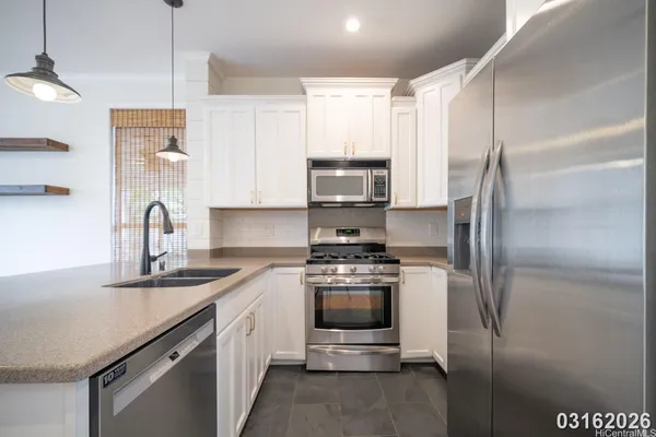 a kitchen with a sink stainless steel appliances and cabinets