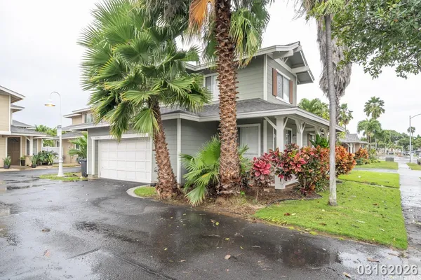 a front view of a house with garden