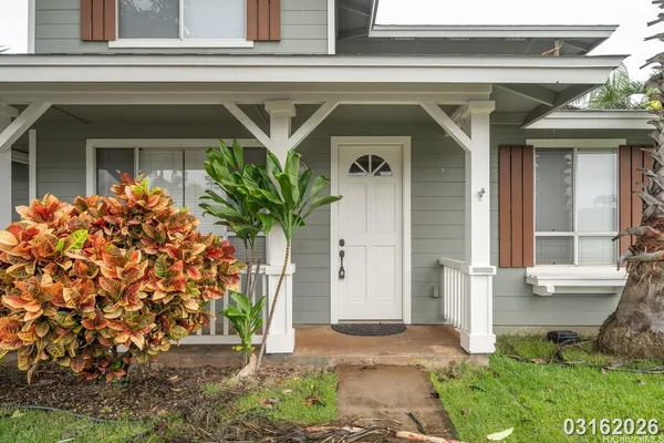 a front view of a house with plants