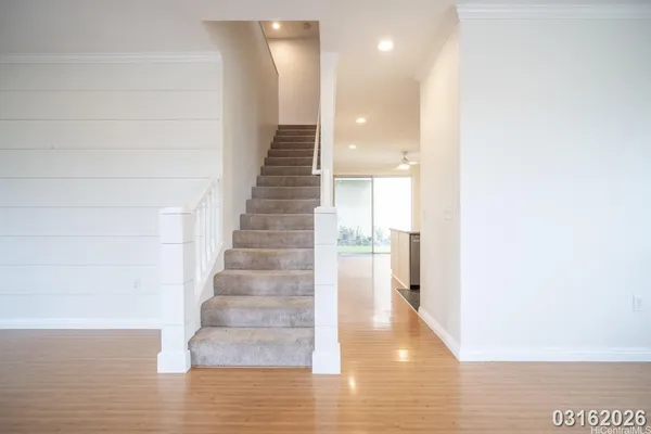 a view of entryway and hall with wooden floor