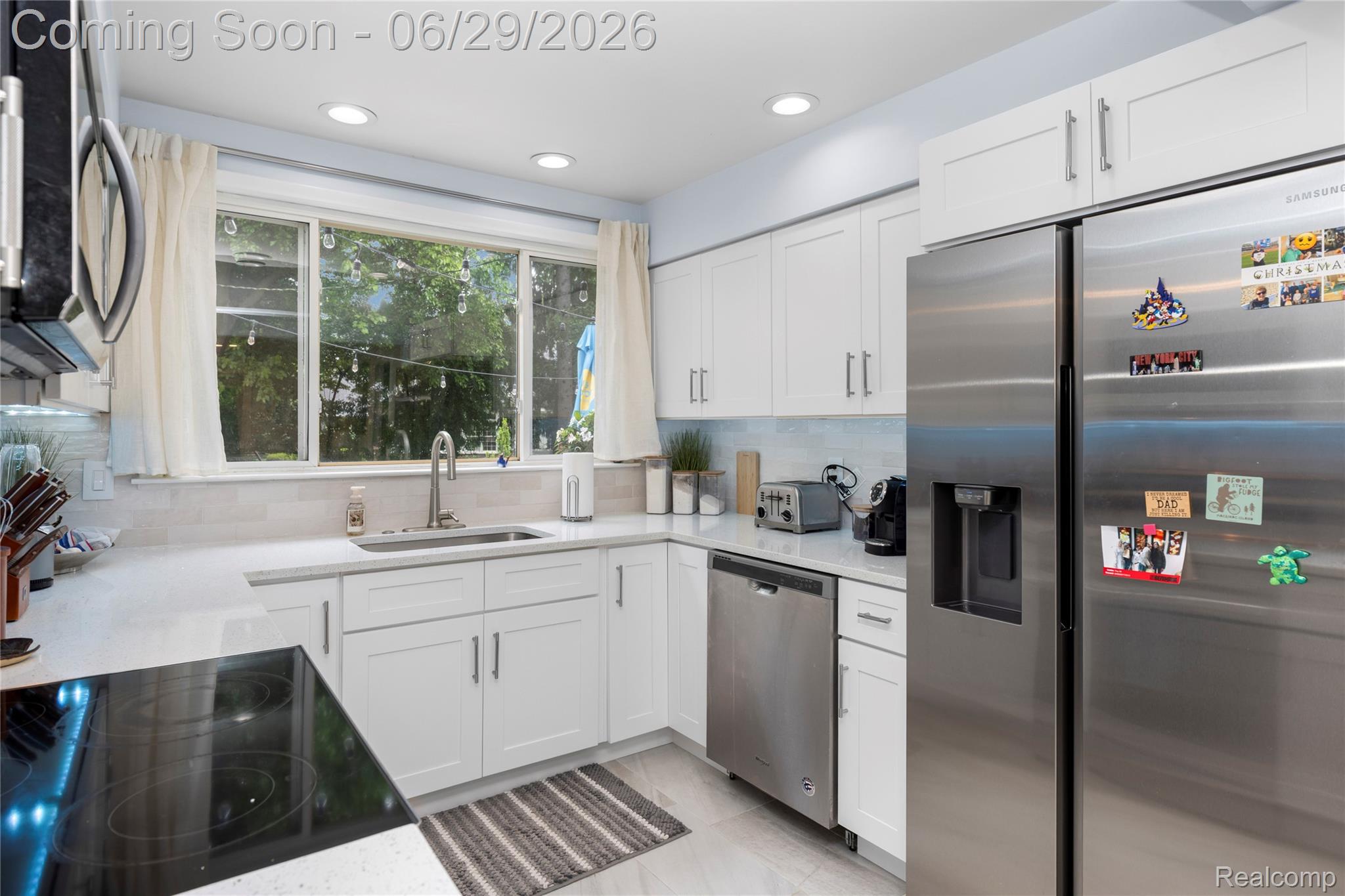 6085 Worlington Road Bloomfield Hills, MI 48301 - Photo 20 of 75 Modern kitchen featuring white shaker cabinetry, stainless steel appliances, light-colored countertops, a tile backsplash, and recessed lighting