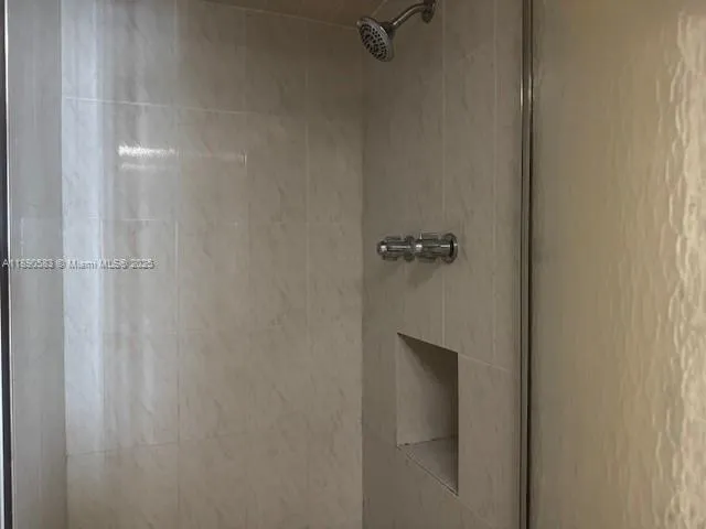 a bathroom with a granite countertop sink a toilet and a mirror