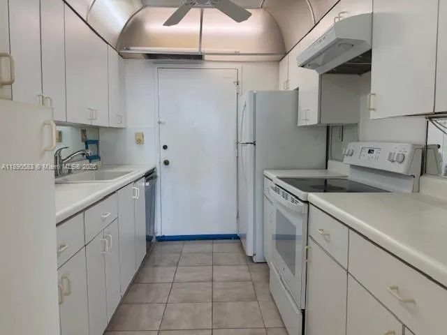 a kitchen with a refrigerator and sink