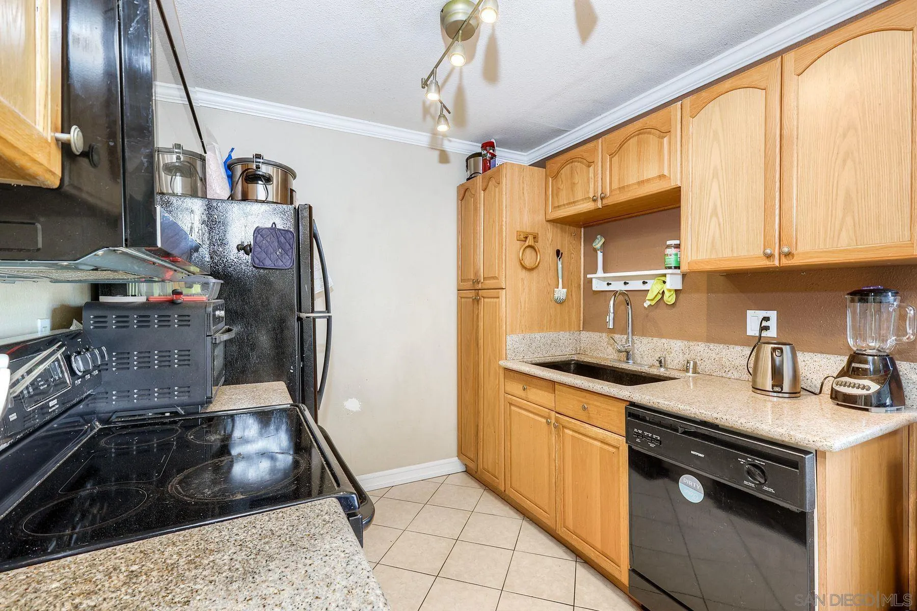 12923 Mapleview Street, Unit 6 Lakeside, CA 92040 - Photo 4 of 25 a kitchen with stainless steel appliances granite countertop a sink a stove and a refrigerator