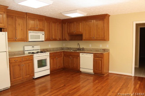 979 Long Road Mathews, VA 23109 - Photo 17 of 39 a kitchen with a stove a sink and a microwave