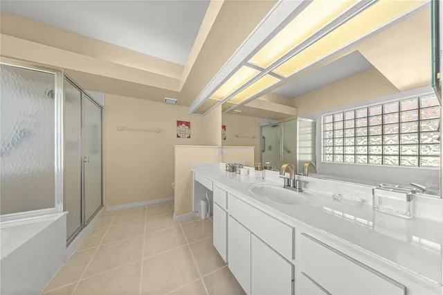 a bathroom with double vanity and a bathtub