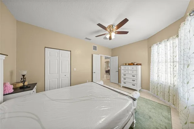 a bedroom with a large bed and a chandelier