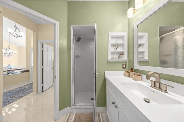 a bathroom with a sink a mirror and a shower