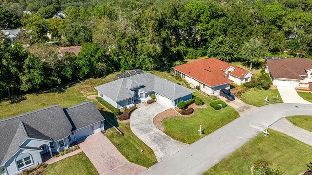 an aerial view of a house with swimming pool garden and patio