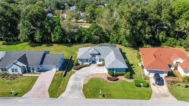 an aerial view of residential house with outdoor space and swimming pool