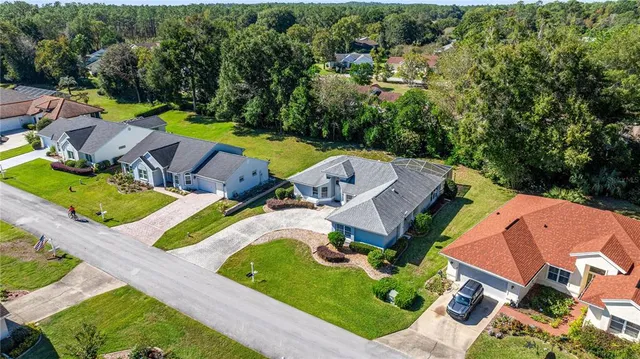 an aerial view of a house with garden space and street view
