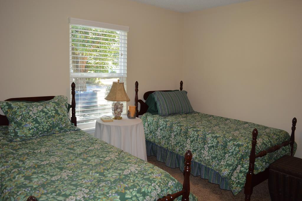 108 Raintree Court Aiken, SC 29803 - Photo 7 of 18 a bedroom with a bed and wooden floor