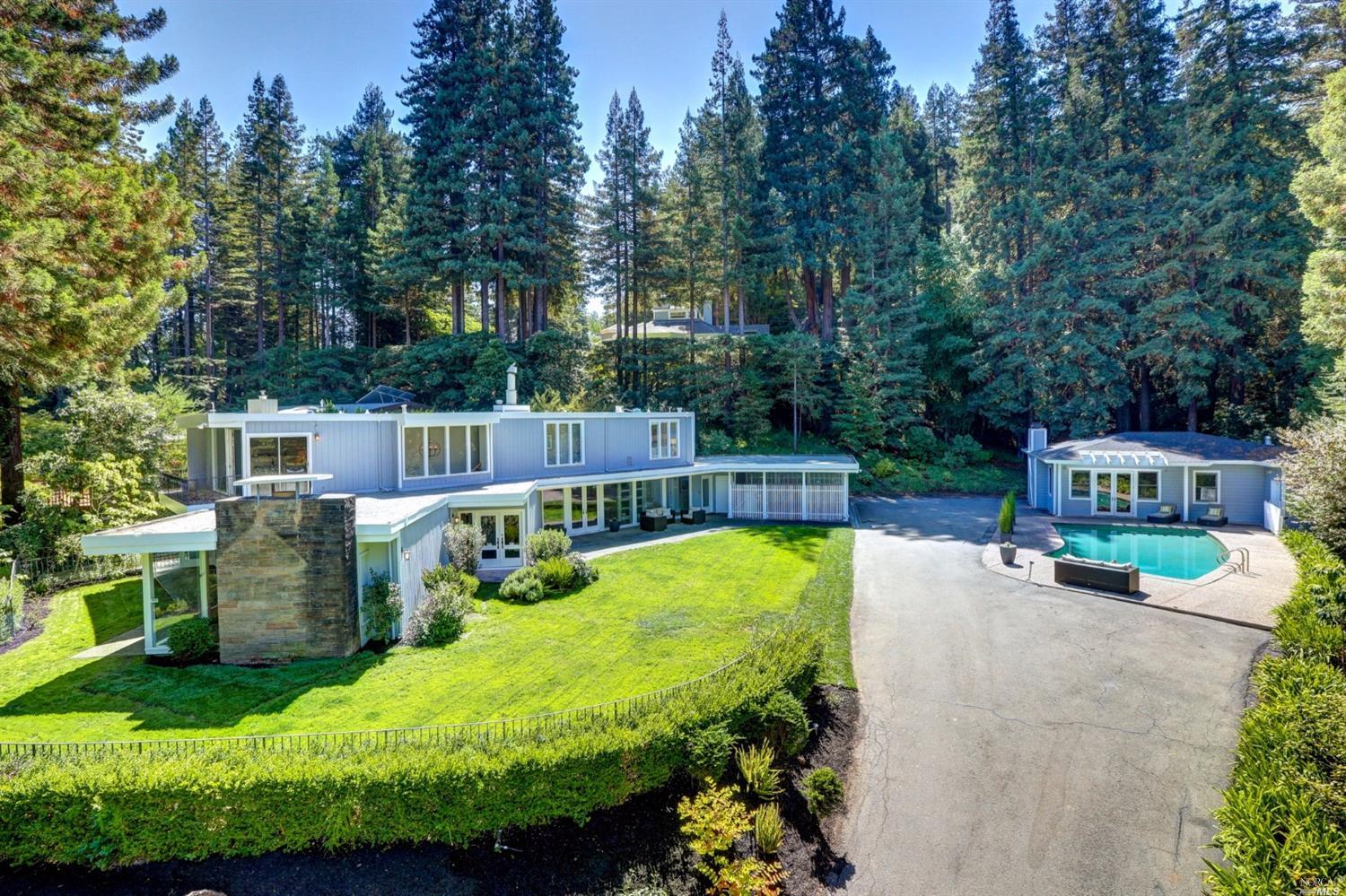 a view of a swimming pool with a patio and a yard