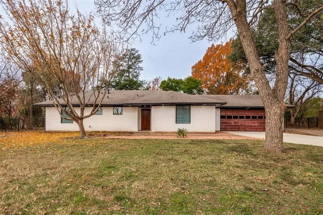 a house that has a tree in front of it