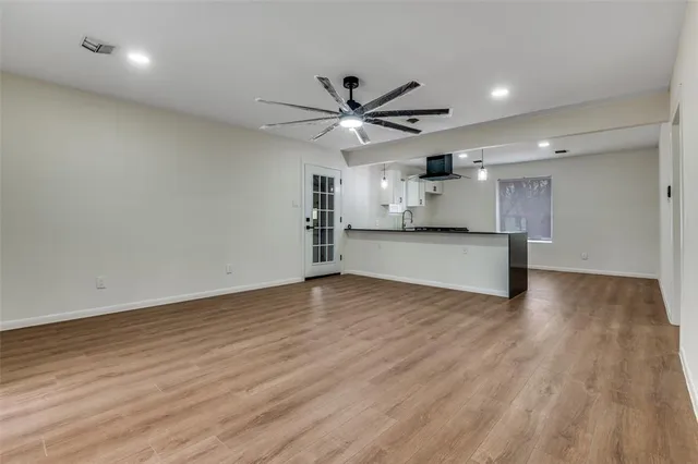 a view of a kitchen with a sink and a refrigerator
