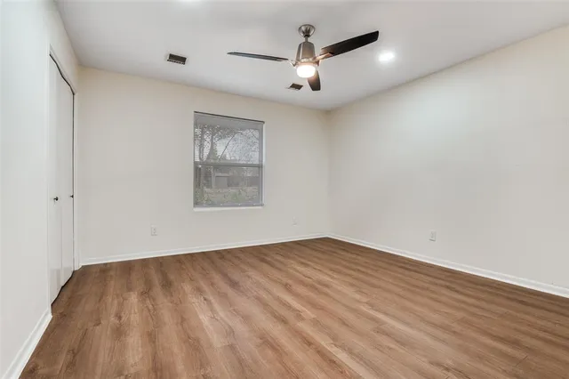 wooden floor in an empty room with a window