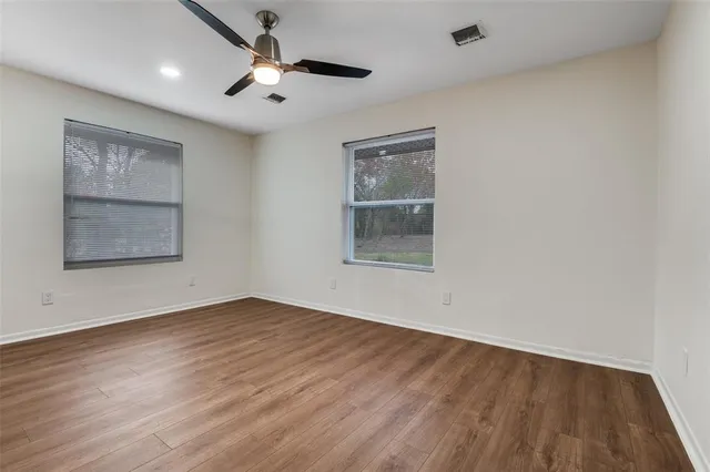 wooden floor in an empty room with a window