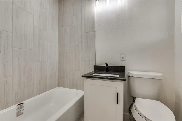 a bathroom with a sink a toilet and bathtub