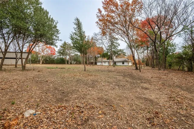 an aerial view of a house with a yard and parking spaces