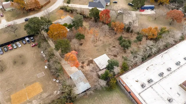 an aerial view of a residential houses with yard