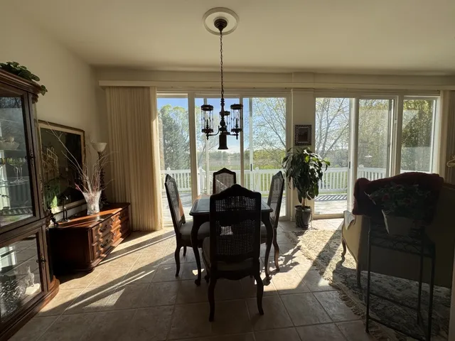a view of a livingroom with furniture and floor to ceiling window