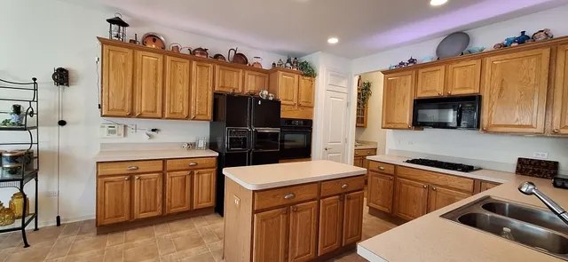 a kitchen that has a sink and a stove in it