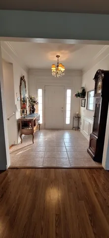 a view of a balcony with chairs and wooden fence