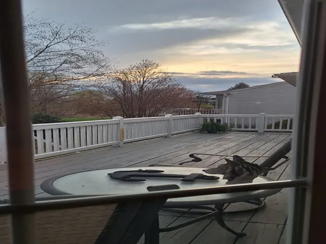 a view of a balcony dining area with furniture