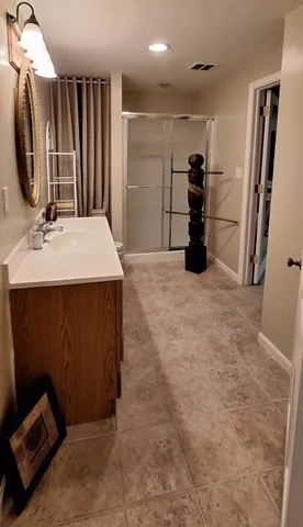 a backyard of a house with lots of green space and lake view in back