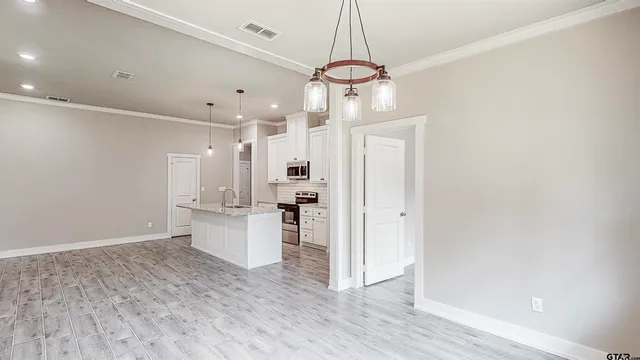 a view of a kitchen and a refrigerator