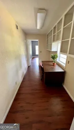 a living room with hard wood floors and a window