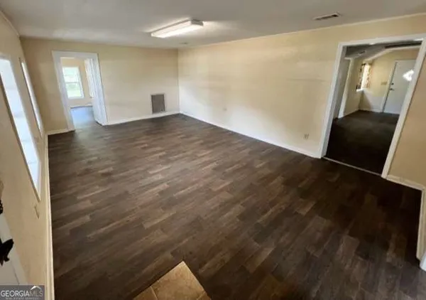 wooden floor in an empty room with a mirror