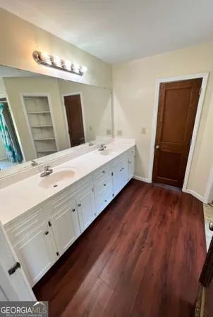 a spacious bathroom with a double vanity sink and a mirror