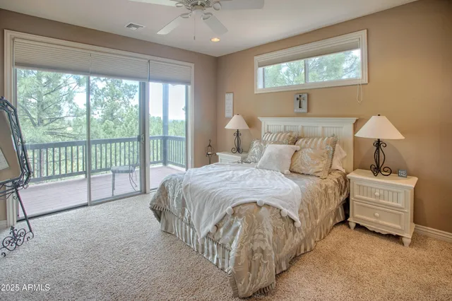 a spacious bedroom with a bed and a large window