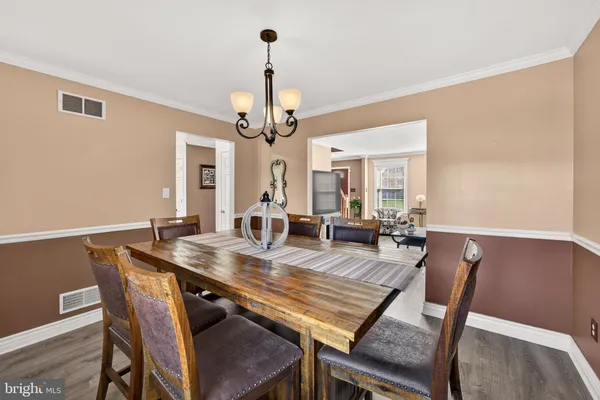 a view of a dining room with furniture wooden floor and chandelier